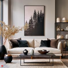 a living room with white couches and black vases on the coffee table in front of it