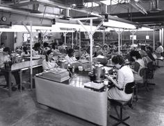 an industrial factory filled with people working on machines