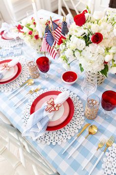 a table set with red, white and blue place settings for an american flag themed party