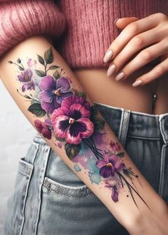 a woman with a flower tattoo on her arm