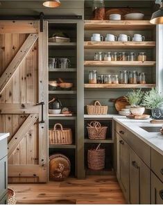 an open pantry with wooden shelves and baskets on the door, next to a sink