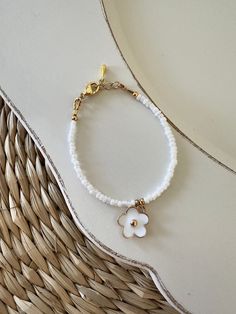 White and gold flower baby bracelet | Baby shower present | Baby bracelet | Baby girl bracelet | Flower bracelet charm West Wood Sign Co D E T A I L S: Gold Plated clasp and chain P L E A S E  R E A D: When measuring wrist add 1/2 inch! All items are handmade and slight variations may occur with each piece.  Follow us on Instagram @WestWoodSignCo https://www.etsy.com/shop/WestWoodSignCo Girl Bracelet, Cadeau Baby Shower, Bracelet Flower, Birthday Flower, Baby Shower Presents, Baby Bracelet, Girl Jewelry, Star Bracelet