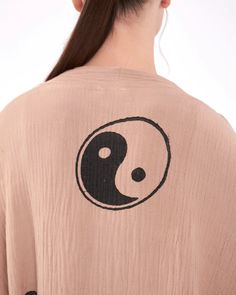 Our YingYang Kimono Robe is crafted from 100% natural cotton muslin, offering a super soft, fluffy, and breathable feel. Handwoven and naturally dyed, this gender-neutral kimono is gentle on your skin and eco-friendly. With an inner tie and convenient pockets, it’s perfect for lounging at home, as beachwear, or for a stylish layer on the go. Lightweight, quick-drying, and absorbent, this robe is as functional as it is fashionable. Material: 100% Natural Cotton, OEKO-TEX Certified Artisan Design: Bohemian Kimono With Natural Dye And Relaxed Fit, Bohemian Kimono With Natural Dye, Bohemian Kimono With Natural Dye In Relaxed Fit, Yin Yang Illustration, Kimono Robes, Music Festival Outfit, Layered Fashion, Boho Kimono, Muslin Fabric