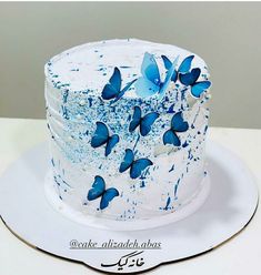 a white cake with blue butterflies on it