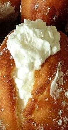 several doughnuts with whipped cream on them