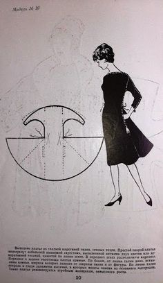 a woman in a black dress is standing next to a drawing on a piece of paper