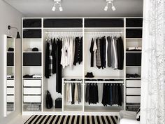 an organized closet with black and white striped carpet