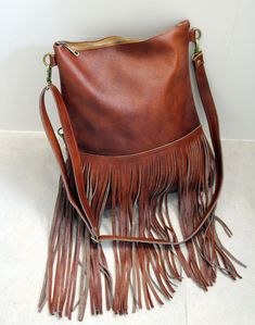 Bohemian fringe bag, cognac leather fringe bag, cognac brown boho bag, festival bag, leather crossbody, handmade leather bag This gorgeous bohemian style bag is crafted with a high quality suede leather and a cowchide leather. It has a top zip closure, and includes an inside pocket. It's cross body feature makes it suitable for a day or night occasion. Light in weight and unique. It is the perfect bag for every season. We use soft genuine leather. This bag is perfect as your everyday bag, which Brown Shoulder Bag With Tassels For Festival, Brown Satchel Bag With Fringe, Brown Fringe Tote Shoulder Bag, Brown Satchel With Fringe, Brown Fringe Satchel Bag, Brown Tassel Tote Shoulder Bag, Bohemian Leather Hobo Bag For Fall, Bohemian Brown Shoulder Bag With Fringe, Brown Fringe Bag For Everyday Use