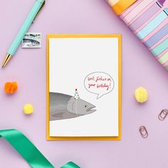 a greeting card with an image of a fish wearing a party hat