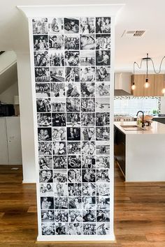 a kitchen wall covered in black and white photos