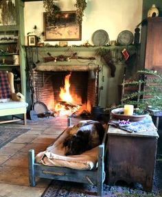 a living room filled with furniture and a fire place in the middle of the room