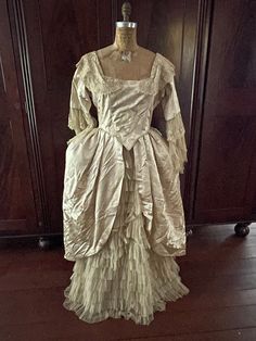 Stunning and very rare Georgian/Victorian Authentic Silk & Tule Antique Ball Gown. Champagne/Ivory in color, damask pink, this dress is from 1830's-1870's or earlier. It has a gorgeous cascade of tule/lace down the front of the dress and arms. Beautiful example of an elegant gown from its time.  There are three small tears on on the back of the dress and two under one of the arms.  It could be fixed by a professional but otherwise the dress is in excellent shape considering the very old age. The Fitted Baroque Victorian Dress For Vintage Events, Victorian Floor-length Dress For Vintage Events, White Vintage Victorian Dress For Fancy Dress, White Victorian Dress For Fancy Dress, Victorian Style Floor-length Fancy Dress, Regency Style Ball Gown For Vintage Events, Regency Style Ball Gown Dresses For Vintage Events, 18th Century Fitted Baroque Dress, Elegant Historical Dress For Vintage Events