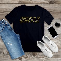 Cotton Hustle t-shirt. Shirt offered in Black and White with matte gold font. Font color can be personalized if desired. Also available in children's sizes. Please message with request. Gold Casual T-shirt With Letter Print, Gold Graphic Tee With Letter Print, Gold Crew Neck T-shirt With Letter Print, Gold Cotton T-shirt With Text Print, Gold Crew Neck T-shirt With Text Print, Gold Short Sleeve T-shirt With Text Print, Mini Christmas Stockings, Santa's Nice List, Ruffled Socks