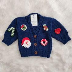 100% HAND MADE: Made from thick wool blend hand knitting yarn, this crochet cardigan is designed to keep your baby comfortable in the cold months. Every step of this Christmas cardigan is 100% handmade. It does not contain chemicals that may affect human health and keeps your little ones warm. COLOR AND SIZE: This toddler cardigan is produced in all sizes, starting from newborn to 0-2 age group. Also, regarding color, if there is a color you want, we can produce this Christmas jacket in that color. PERSONALIZED PATTERN: The patterns on this knitted cardigan can be changed upon your request and personalized holiday patterns can be created. Do not hesitate to contact us regarding this issue. CARDIGAN INSTRUCTIONS: These instructions are for washing a garment and should be followed to ensure Cute Winter Sweater As A Gift, Winter Crochet Acrylic Yarn Cardigan, Cute Crochet Cardigan For Winter, Cute Crochet Winter Cardigan, Handmade Sweater As Winter Gift, Handmade Sweater Winter Gift, Newborn Winter Clothes, Newborn Cardigan, Valentine's Day Crochet