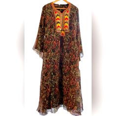 Long Maxi Dress Brown Red Black Tan Floral Print Maxi Length /Maxi Dress Kurta Sequence Designed Front Neck Collar Pattern Of Red Gold Brown Yellow Red Blue Sequences . Along With Brown Beaded Detail 23 Inch Bell Sleeves 21 Inches Armpit To Armpit 56 Inches Shoulder To Hem Modern / Hippie / Boho / Calypso / Resort/ Beach/ Island /Anthropologie/Vintage/ Grandma’s Shift’s/ Silk Maxi Kurta With Floral Print, Bohemian Georgette Kaftan With Floral Print, Silk Kurta With Floral Print In Maxi Length, Summer Bohemian Georgette Kurta, Bohemian Flowy Georgette Maxi Dress, Flowy Bohemian Georgette Maxi Dress, Bohemian Georgette Kurta For Summer, Bohemian Silk Kurta For Festive Occasions, Traditional Multicolor Georgette Kaftan