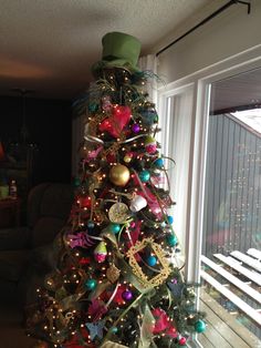 a decorated christmas tree in front of a window