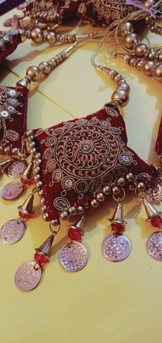 Luxury Jewelry With Latkans For Rituals, Luxury Latkans Jewelry For Navratri, Traditional Red Jewelry With Tassels, Festive Bohemian Jewelry With Handwork, Gold Tassel Necklace For Festivals, Festive Red Tasseled Jewelry, Traditional Tassel Necklace For Festival, Handmade Traditional Tassel Necklace Gift, Cloth Tassels