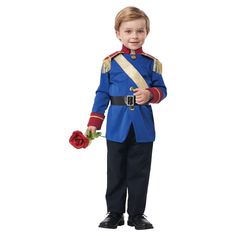 a young boy dressed in a blue uniform and holding a red rose while standing up