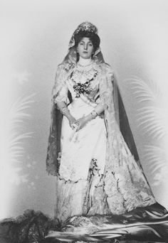 an old black and white photo of a woman in a wedding dress