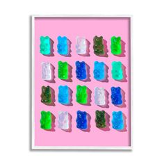 gummy bears are arranged on a pink background with green and blue gummy bears