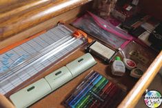 an assortment of crafting supplies sitting on a table with writing utensils and pencils