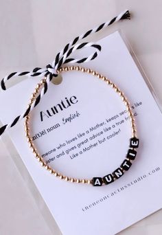 "This gold filled bracelet is dainty and simple. Perfect bracelet to add to your stack or gift to the special Aunti in your life! 3mm gold filled beads paired with black letter beads spelling Auntie! Comes with card and ribbon as pictured making it perfect for gifting!  *This bracelet will not fade or tarnish. Swim, sweat and water proof. *If unsure what size to order measure your wrist and order 1/2\" larger than actual wrist size." Auntie Bracelet, Neon Cactus, New Aunt, Pregnancy Announcement Gifts, Acrylic Letters, How To Make Ribbon, Letter Beads, Name Bracelet, Black Letter