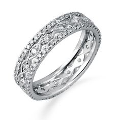 a diamond set wedding ring with intricate design on the sides and center, in white gold