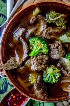 beef and broccoli stew in a brown bowl