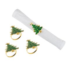 three christmas tree rings on top of a white napkin with two other pieces in the background