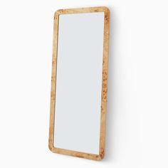 a wooden mirror mounted to the side of a wall