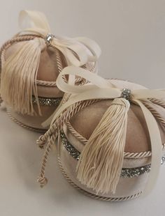 two shoes with tassels and bows on them