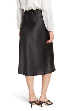 Elevate your wardrobe with this pull-on bias satin midi skirt for elegant, feminine style. 31" length (size S) Elasticized waist Pull-on style Satin construction 97% polyester, 3% spandex Machine wash cold, line dry Made in USA Model’s stats for sizing: 5’10” height, 34” bust, 27” waist, 35” hips. Model is wearing size S. Satin Midi-length Bottoms For Work, Satin Midi Bottoms For Workwear, Relaxed Satin Pencil Midi Skirt, Relaxed Fit Satin Midi Pencil Skirt, Evening Satin Knee-length Skirt, Formal Satin Knee-length Skirt, Formal Knee-length Satin Skirt, Chic Satin Knee-length Bottoms, Satin Flared Skirt For Work