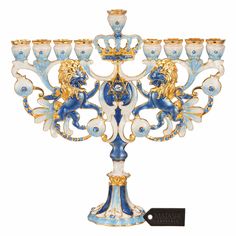 a fancy blue and gold candelabra with two lions on it's sides