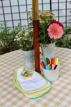 a potted plant sitting on top of a table next to a white and yellow checkered table cloth