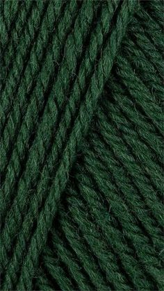 green wool yarn ball on white background