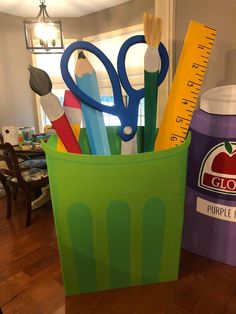 there is a cup with scissors and pencils in it