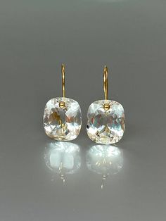 Gorgeous sparkly natural rock crystal drop earrings. The Faceted drops are flawless and sparkle like diamonds. The drops are attached to 24k gold vermeil ear wires. The earrings are elegant and have a lux look. A truly gorgeous pair of earrings. When 14K SOLID GOLD ear wires are being used, the ear wire ends are hand stamped as proof of being 14K solid gold. In addition, extra work was done at the end of the ear wires to prevent any sort of pain or injury while inserting them through the ear lob Cheap Hypoallergenic Crystal Earrings, Formal Faceted Drop Crystal Earrings, Faceted Crystal Drop Earrings For Formal Occasions, Faceted Crystal Drop Earrings For Formal Events, Formal Faceted Crystal Drop Earrings, Dazzling Drop Crystal Earrings For Gifts, White Cushion Cut Earrings As A Gift, Faceted Crystal Earrings For Formal Occasions, Elegant White Faceted Crystal Earrings