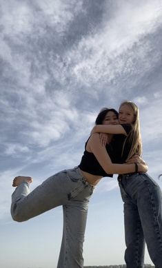 two girls are hugging each other on the beach