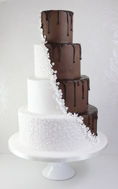 three tiered cake with chocolate frosting on top