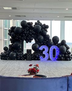 a large balloon arch with the number 30 displayed in it's centerpieces