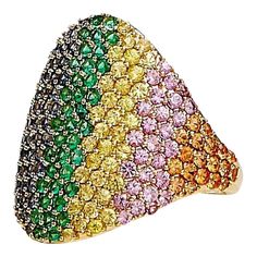 Created in 18 karat yellow gold  Emeralds 0.45 carat approx.  Multicolor sapphires 2.75 carats approx.  Ring size US 7, can be sized up or down  Limited edition    Fashioned from 18k yellow gold, this luxe, limited-edition ring sparkles with a triumvirate of gemstones: a 0.45 carat emerald and 2.75 carats of multicolor sapphires. Its size is a US 7, although can be adjusted accordingly.    About the Designers ~ Dharmesh & Namrata    Drawing inspiration from little things, Dharmesh & Namrata Kothari have created an extraordinary and refreshing collection of luxurious jewels. True believers of destiny, they always feel that the possibilities of design - and life - are limitless when people work together. Formed in 2003, Syna Jewels has grown through enduring relationships with well known, es Luxury Multicolor Multi-stone Sapphire Ring, Yellow Multi-stone Sapphire Ring, Luxury Multicolor Sapphire Ring, Multicolor Brilliant Cut Sapphire Ring For Formal Occasions, Multicolor Brilliant Cut Sapphire Ring, Multicolor Sapphire Ring With Brilliant Cut, Luxury Multicolor Sapphire Ring For Formal Occasions, People Working Together, Rainbow Ring