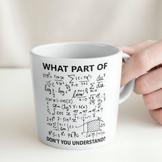 a person holding a coffee mug with some writing on it that says, what part of? don't you understand?