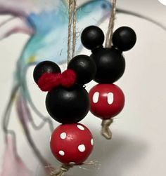 the mickey mouse ornament is hanging on a string with two balls attached to it