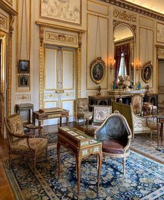 an ornately decorated living room with antique furniture