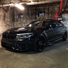 a black car parked in a parking garage