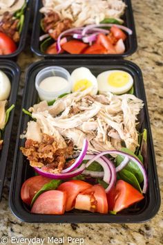 four plastic trays filled with different types of food