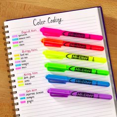 an open notebook with markers on it and the words color code written in different colors