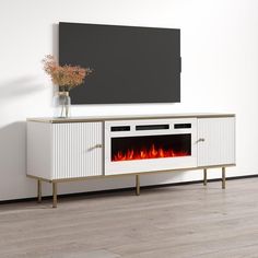 a television stand with a fireplace in the center and a vase on top of it