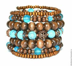 a stack of bracelets with wooden beads and turquoise stones