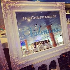 a white frame with the word valentineino on it in front of a store window